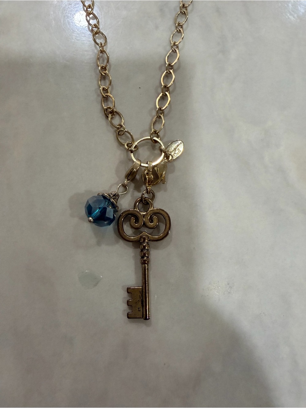 Gold-Tone Key Pendant Necklace with Blue Crystal Accent